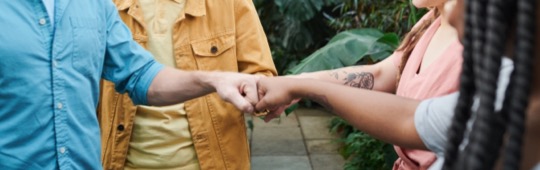 group of people with fist bump