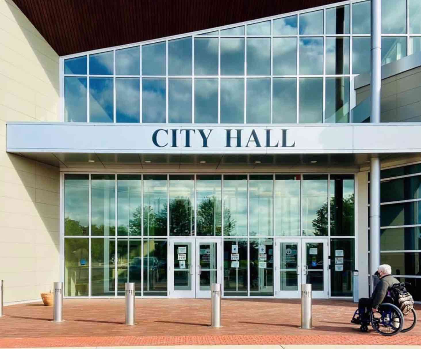picture of man in wheelchair in front of a city hall