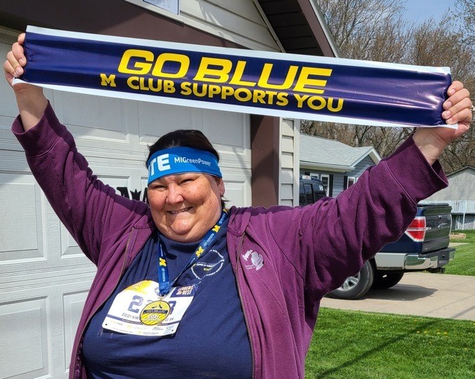 staff member holding go blue sign