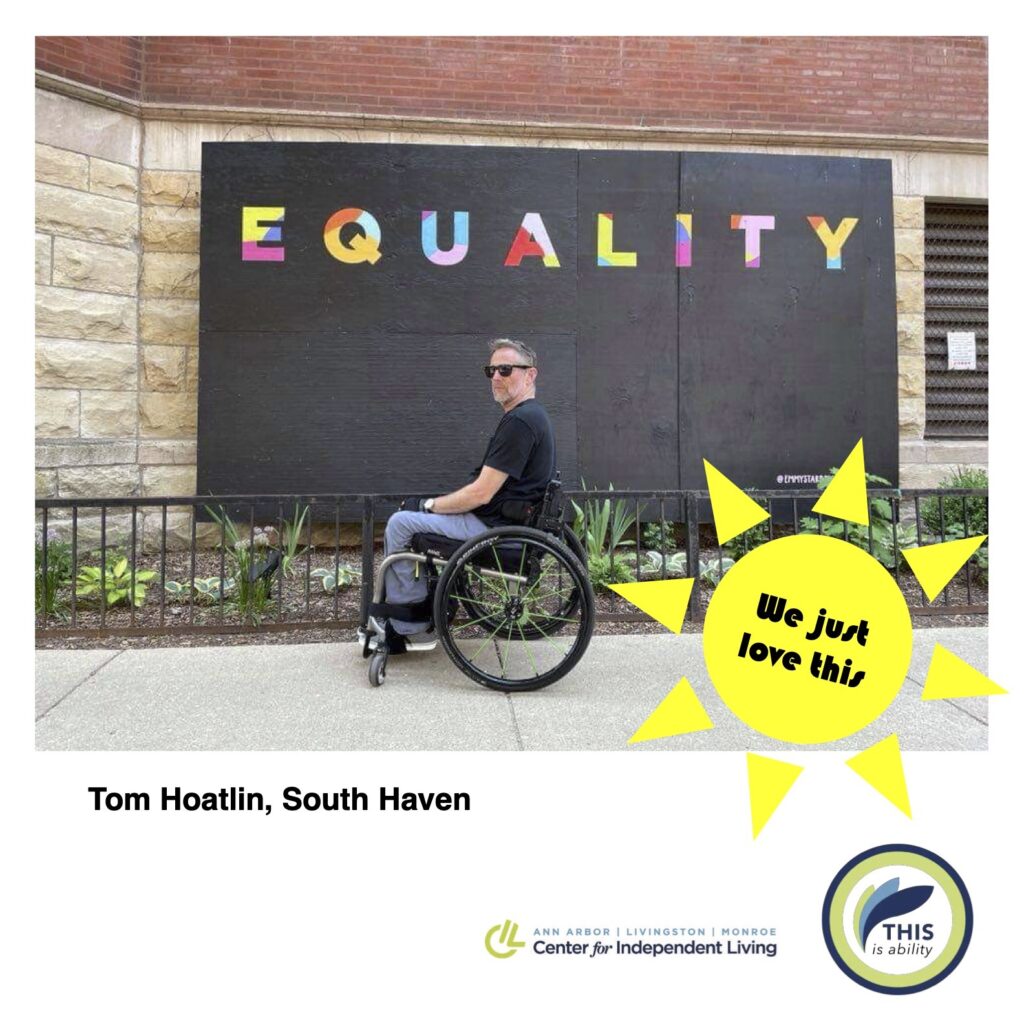 Tom Hoatlin, South Haven, in front of equality sign in Chicago